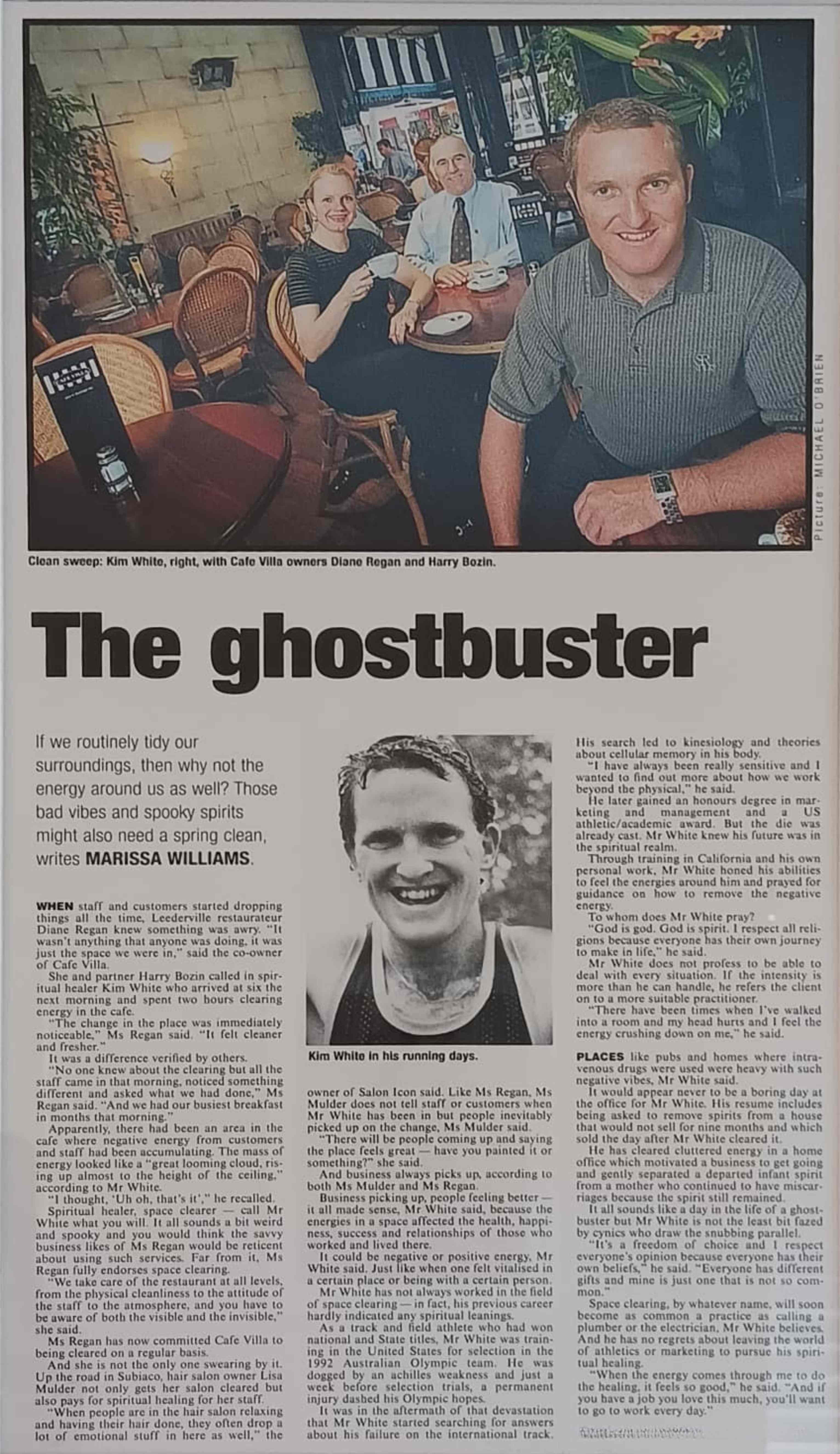 Newspaper article titled 'The Ghostbuster' featuring Daniel White seated with Cafe Villa owners Diane Regan and Harry Bozin, written by Marissa Williams in 2001.